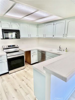 Interior, Kitchen, Stainless Steel Appliances, Tile Countertops, Wood Texture Flooring