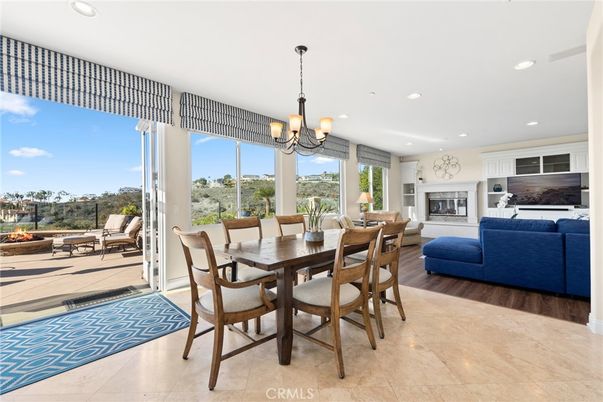 Chandelier, Dining room, Fireplace, Interior, Living room, Pendant Lights, Recessed Lighting, Wood Texture Flooring