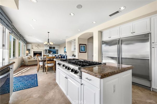 Chandelier, Dining room, Fireplace, Interior, Kitchen, Living room, Recessed Lighting, Stainless Steel Appliances