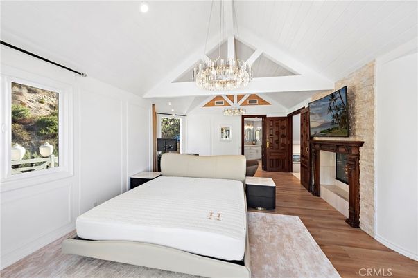 Bedroom, Chandelier, Fireplace, Interior, Recessed Lighting, Wood Texture Flooring
