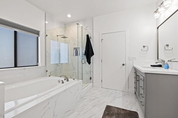 Bathroom, Dual Sink Vanities, Glass Shower, Interior, Marble, Marble Walls, Recessed Lighting