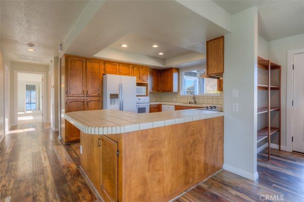 Interior, Kitchen, Recessed Lighting, Tile Countertops, Wood Texture Flooring