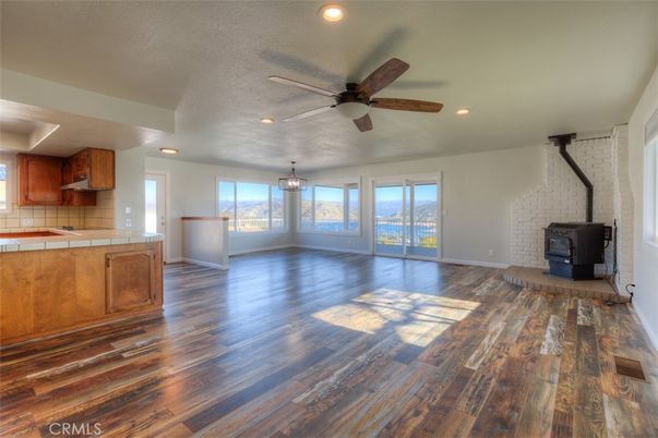 Empty room, Fireplace, Interior, Kitchen, Pendant Lights, Recessed Lighting, Stone Walls, Wood Texture Flooring