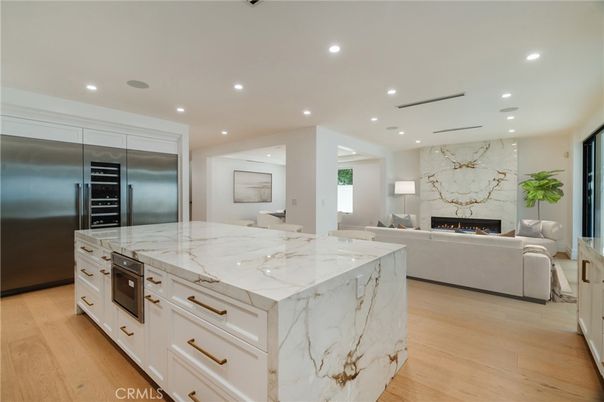 Fireplace, Interior, Kitchen, Living room, Marble Walls, Recessed Lighting, Stainless Steel Appliances, Wood Texture Flooring