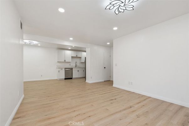 Empty room, Interior, Kitchen, Recessed Lighting, Stainless Steel Appliances, Wood Texture Flooring