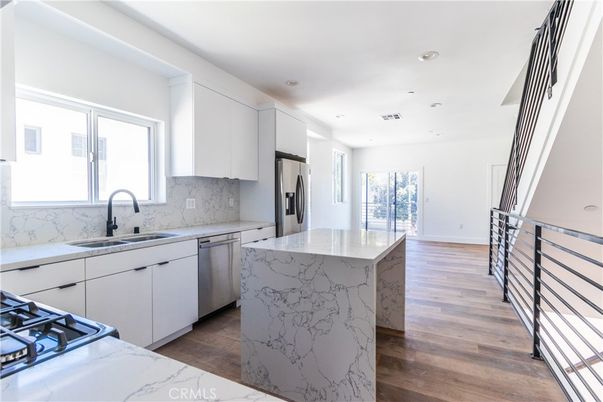 Interior, Kitchen, Marble Walls, Recessed Lighting, Stainless Steel Appliances, Wood Texture Flooring