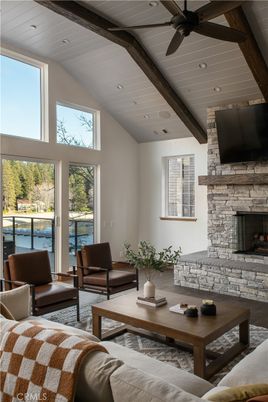 Fireplace, Interior, Living room, Recessed Lighting, Stone Walls, Water, Wooden Beams