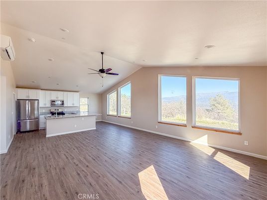 Empty room, Interior, Kitchen, Recessed Lighting, Stainless Steel Appliances, Wood Texture Flooring
