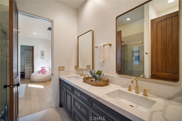 Bathroom, Dual Sink Vanities, Glass Shower, Interior, Recessed Lighting, Tile Countertops, Wood Texture Flooring