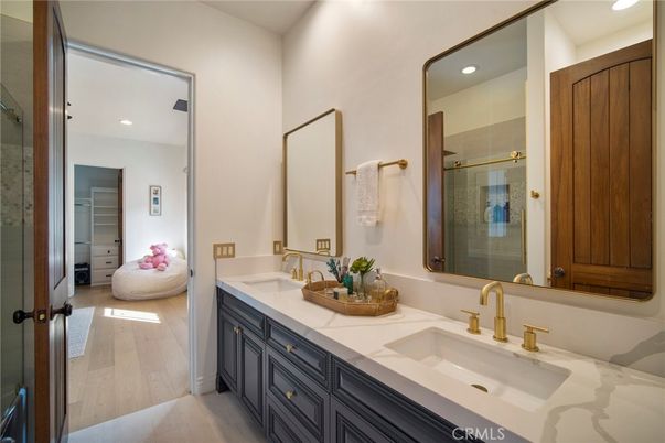 Bathroom, Dual Sink Vanities, Glass Shower, Interior, Recessed Lighting, Tile Countertops, Wood Texture Flooring