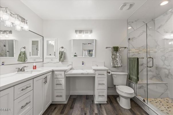 Bathroom, Dual Sink Vanities, Glass Shower, Interior, Marble Walls, Recessed Lighting, Wood Texture Flooring