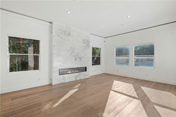Empty room, Fireplace, Interior, Marble Walls, Recessed Lighting, Wood Texture Flooring