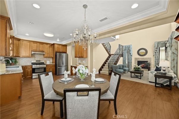 Chandelier, Dining room, Fireplace, Interior, Kitchen, Living room, Recessed Lighting, Stainless Steel Appliances, Wood Texture Flooring