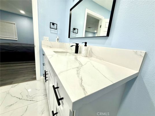 Bathroom, Dual Sink Vanities, Interior, Marble, Recessed Lighting, Wood Texture Flooring