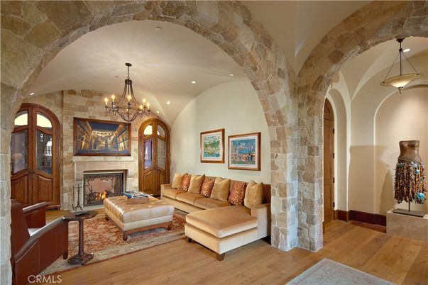 Chandelier, Fireplace, Interior, Living room, Pendant Lights, Recessed Lighting, Stone Walls, Wood Texture Flooring