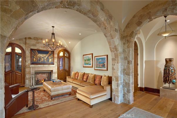Chandelier, Fireplace, Interior, Living room, Recessed Lighting, Stone Walls, Wood Texture Flooring