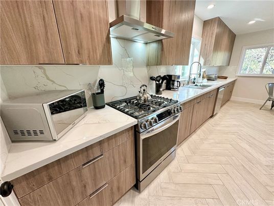 Interior, Kitchen, Marble Walls, Recessed Lighting, Stainless Steel Appliances, Wood Texture Flooring