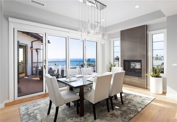 Dining room, Fireplace, Interior, Pendant Lights, Recessed Lighting, Water, Wood Texture Flooring