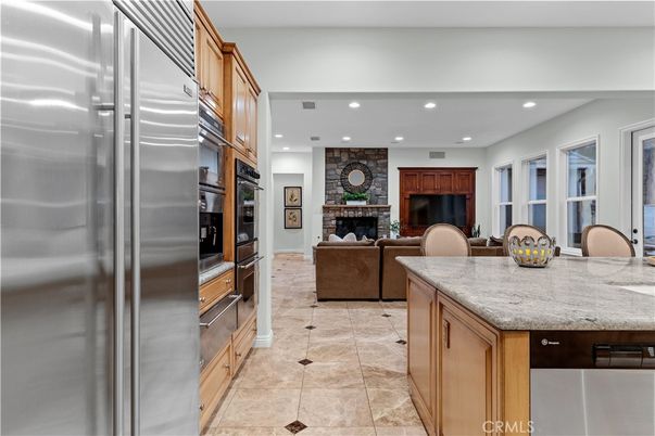 Fireplace, Interior, Kitchen, Living room, Recessed Lighting, Stainless Steel Appliances, Stone Walls