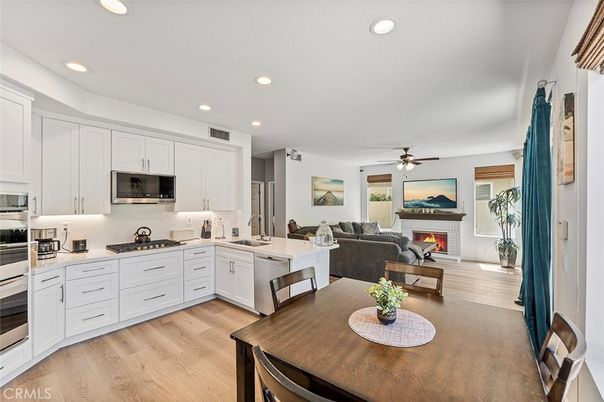 Dining room, Fireplace, Interior, Kitchen, Living room, Recessed Lighting, Stainless Steel Appliances, Wood Texture Flooring