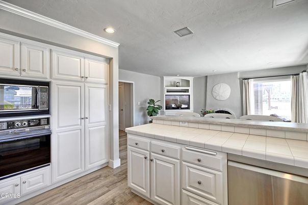 Interior, Kitchen, Recessed Lighting, Stainless Steel Appliances, Tile Countertops, Wood Texture Flooring
