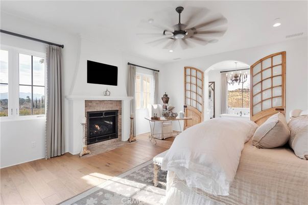 Bedroom, Chandelier, Fireplace, Interior, Recessed Lighting, Wood Texture Flooring