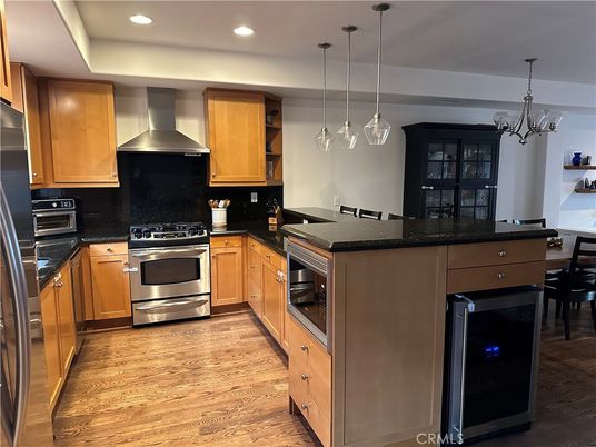 Chandelier, Dining room, Interior, Kitchen, Pendant Lights, Recessed Lighting, Stainless Steel Appliances, Wood Texture Flooring