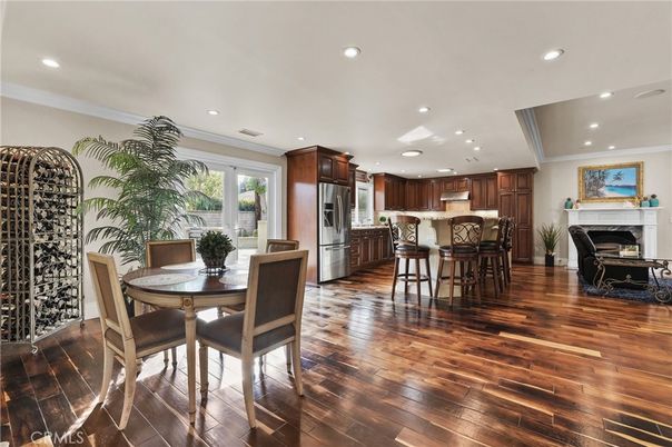 Dining room, Fireplace, Interior, Kitchen, Recessed Lighting, Stainless Steel Appliances, Wood Texture Flooring