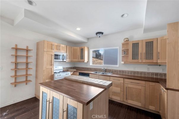 Interior, Kitchen, Recessed Lighting, Stainless Steel Appliances, Tile Countertops, Wood Texture Flooring