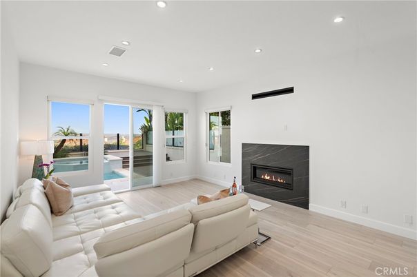 Fireplace, Interior, Living room, Recessed Lighting, Water, Wood Texture Flooring