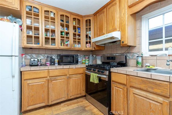 Interior, Kitchen, Stainless Steel Appliances, Tile Countertops, Wood Texture Flooring