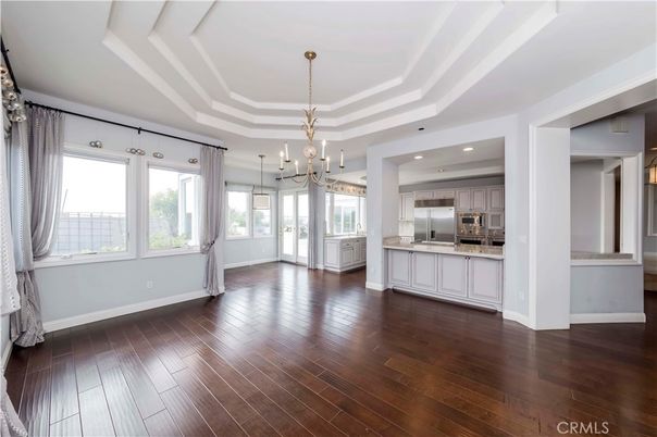 Chandelier, Empty room, Interior, Kitchen, Pendant Lights, Recessed Lighting, Stainless Steel Appliances, Wood Texture Flooring