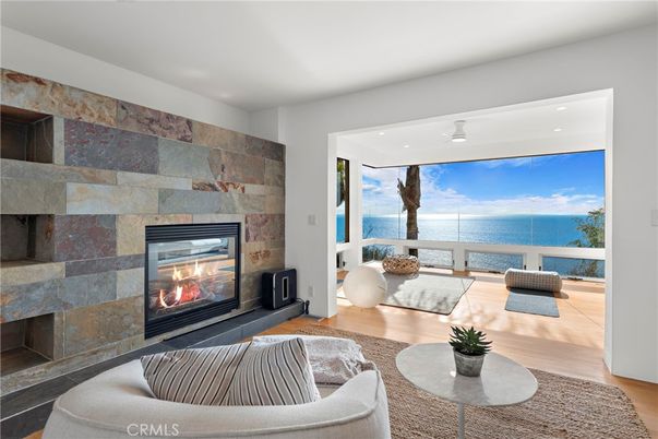 Fireplace, Interior, Living room, Recessed Lighting, Stone Walls, Water, Wood Texture Flooring