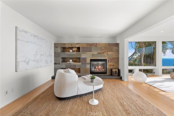 Fireplace, Interior, Living room, Recessed Lighting, Stone Walls, Water, Wood Texture Flooring