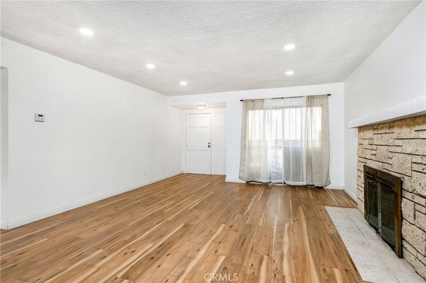 Empty room, Fireplace, Interior, Recessed Lighting, Stone Walls, Wood Texture Flooring
