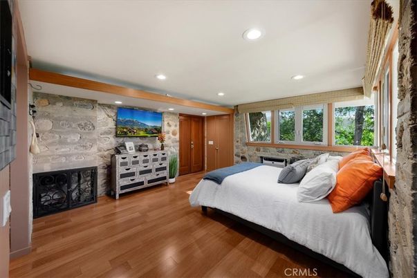 Bedroom, Fireplace, Interior, Recessed Lighting, Stone Walls, Wood Texture Flooring