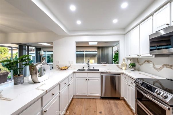 Interior, Kitchen, Recessed Lighting, Stainless Steel Appliances, Washer, Wood Texture Flooring