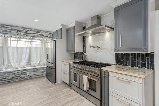 Interior, Kitchen, Marble Walls, Recessed Lighting, Stainless Steel Appliances, Wood Texture Flooring