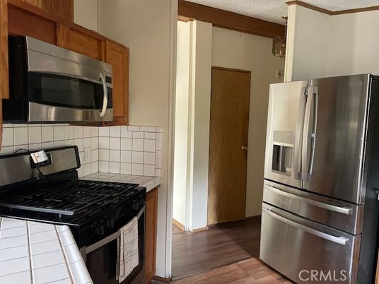 Interior, Kitchen, Stainless Steel Appliances, Tile Countertops, Wood Texture Flooring