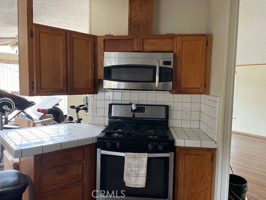 Interior, Kitchen, Stainless Steel Appliances, Tile Countertops, Wood Texture Flooring