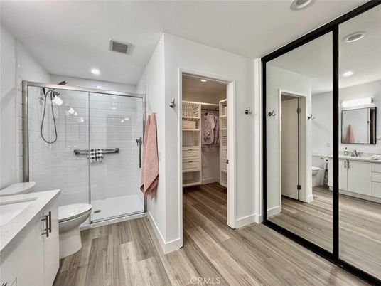 Bathroom, Dual Sink Vanities, Glass Shower, Interior, Recessed Lighting, Wood Texture Flooring