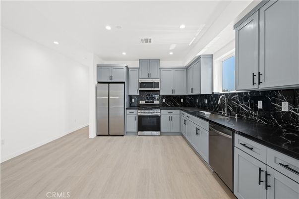 Interior, Kitchen, Marble Walls, Recessed Lighting, Stainless Steel Appliances, Wood Texture Flooring