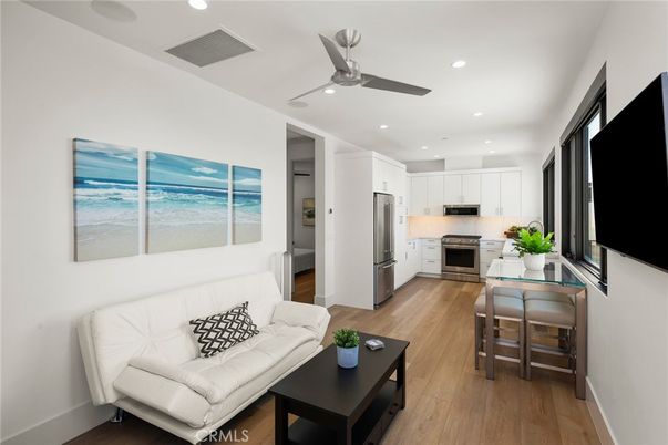 Dining room, Interior, Kitchen, Living room, Recessed Lighting, Stainless Steel Appliances, Water, Wood Texture Flooring