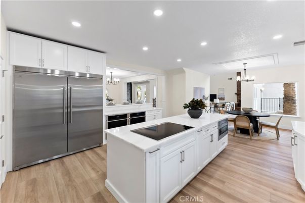 Chandelier, Dining room, Interior, Kitchen, Recessed Lighting, Stainless Steel Appliances, Wood Texture Flooring