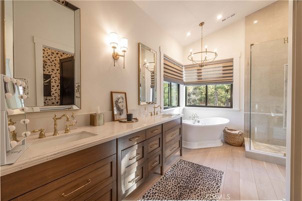 Bathroom, Chandelier, Dual Sink Vanities, Free Standing Baths, Glass Shower, Interior, Pendant Lights, Recessed Lighting, Wood Texture Flooring