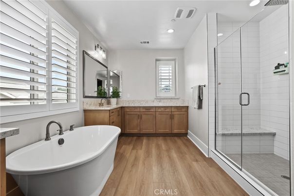 Bathroom, Dual Sink Vanities, Free Standing Baths, Glass Shower, Interior, Recessed Lighting, Wood Texture Flooring