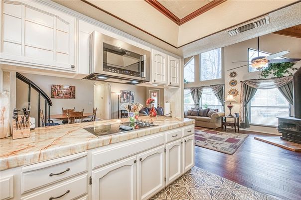 Dining room, Fireplace, Interior, Kitchen, Living room, Tile Countertops, Wood Texture Flooring