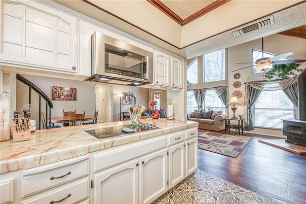Dining room, Fireplace, Interior, Kitchen, Living room, Tile Countertops, Wood Texture Flooring