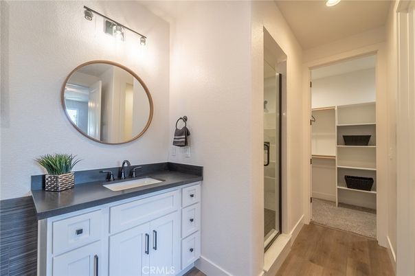 Bathroom, Dual Sink Vanities, Glass Shower, Interior, Recessed Lighting, Walk-in Closets, Wood Texture Flooring