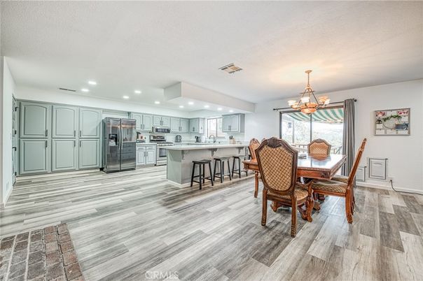 Chandelier, Dining room, Interior, Kitchen, Recessed Lighting, Stainless Steel Appliances, Wood Texture Flooring
